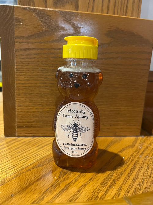 Tricounty Farm 12 oz honey bear bottle with a classic design, featuring a yellow plastic bear shape and a flip-top cap.