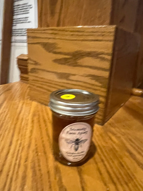12 oz Tricounty Farm honey jar with honeycomb, featuring a golden amber color and a rustic glass design.