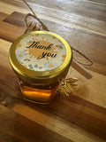 Tiny 1.5-ounce honey pot from Tricounty Farm, featuring a rustic design and golden honey inside.